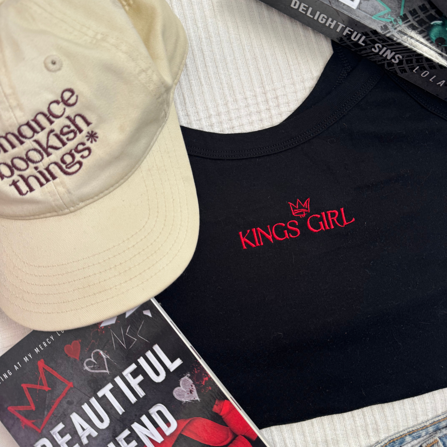 Black t-shirt with 'Kings Girl' embroidery flat lay. Based on Beautiful Fiend by Lola King