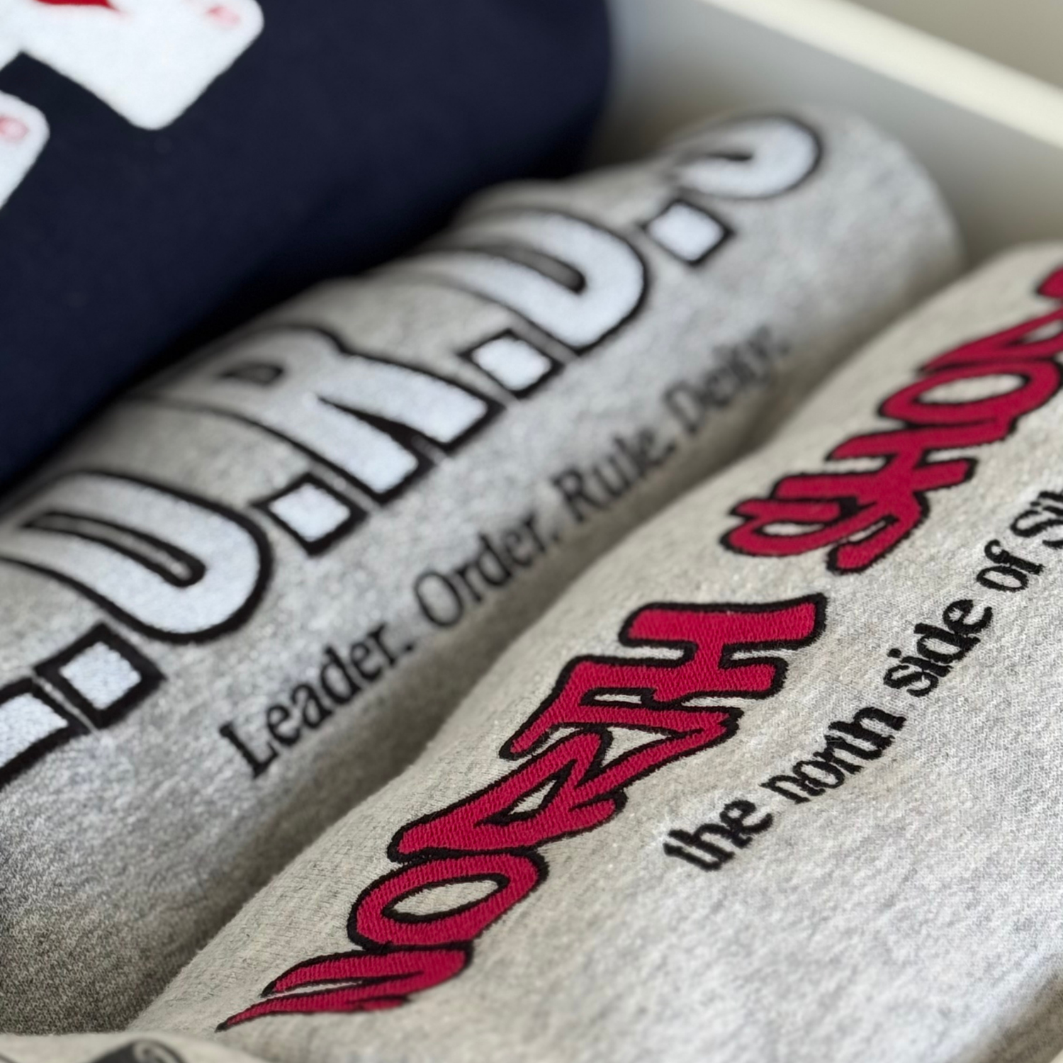 Close-up of a textured surface bookish sweatshirt embroidery