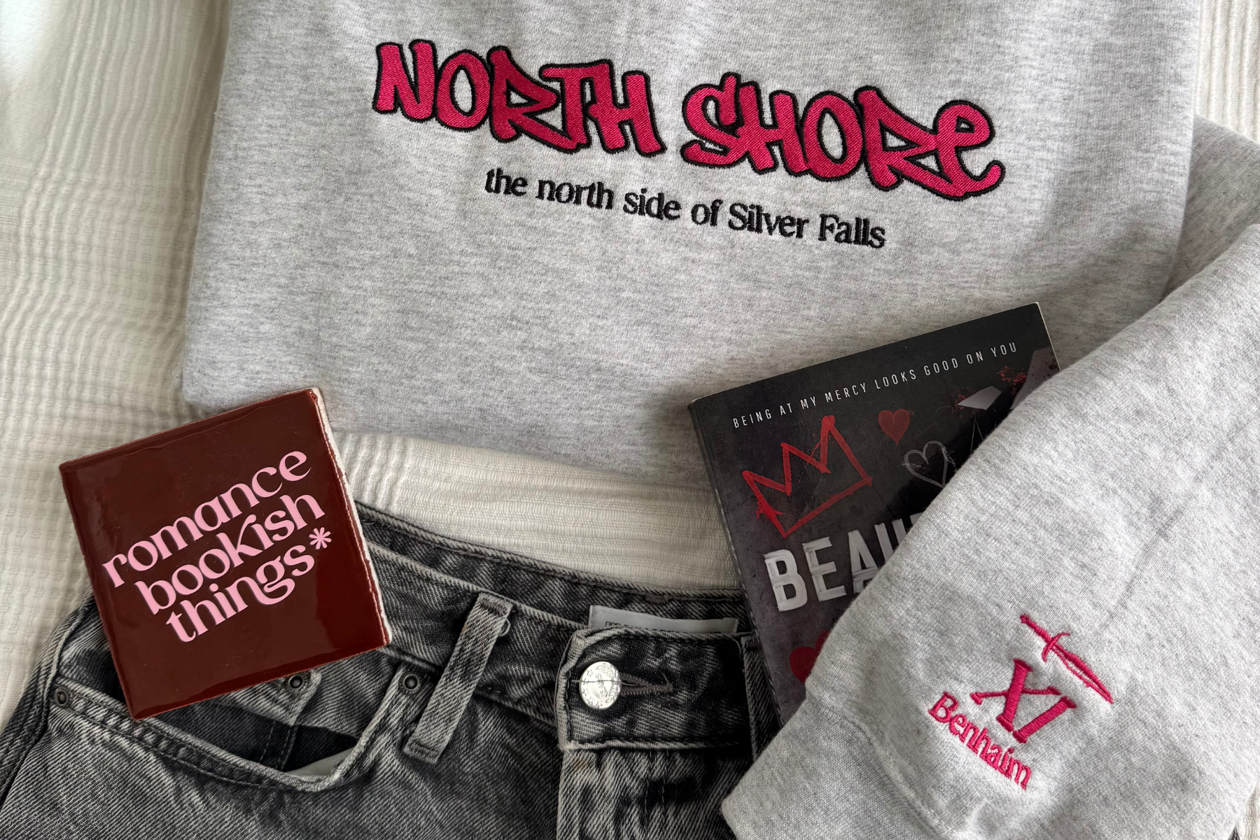 Flatlay of an embroidered licensed romance merch shirt from Romance Bookish Things